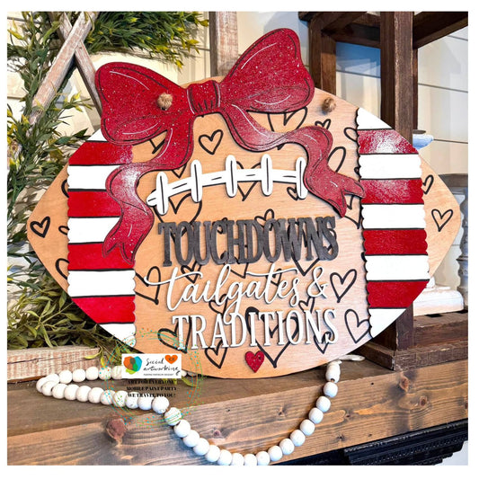 Touchdowns Tailgates & Traditions with hearts etched on Football with bow 2-D Wood Door Hanger